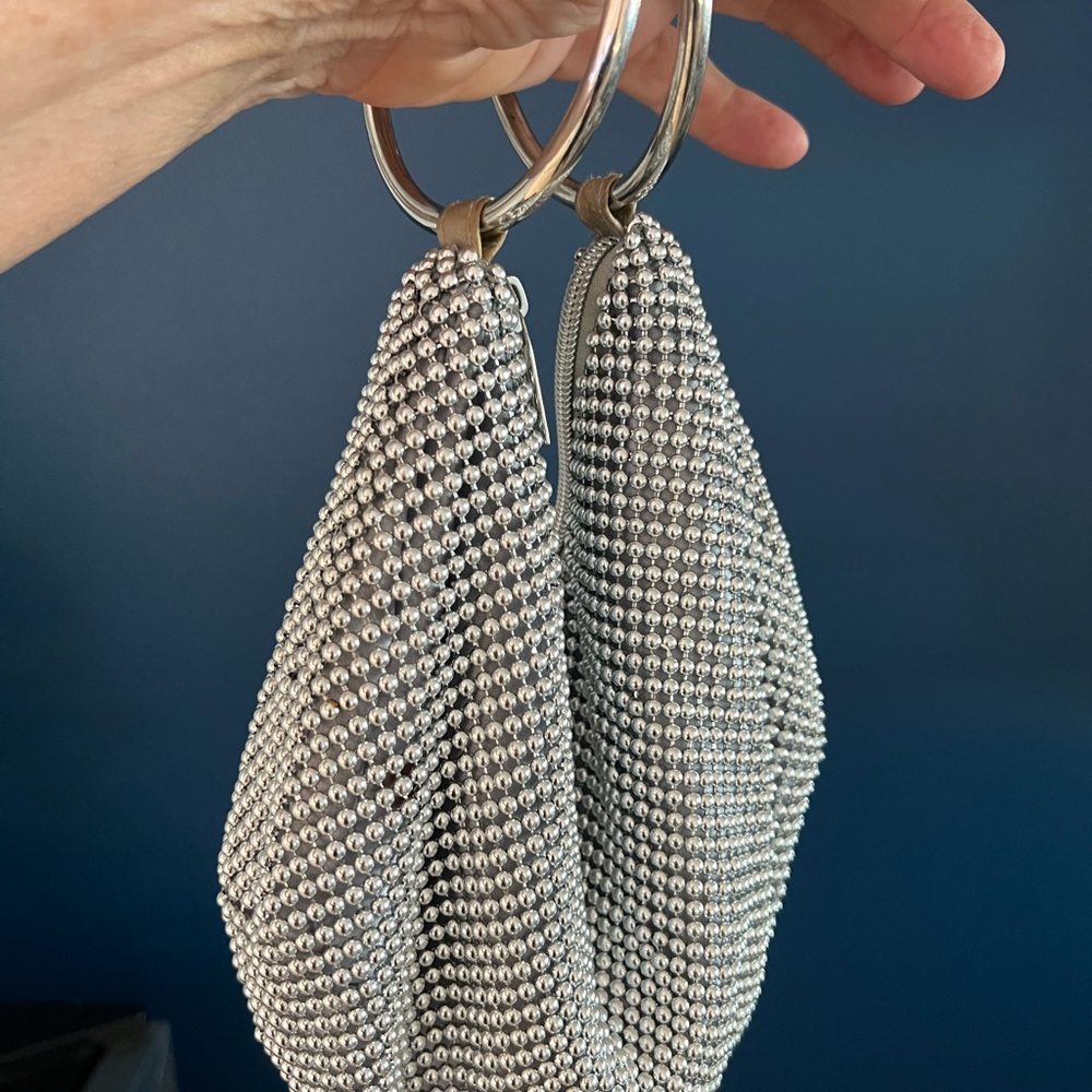 Jessica McClntock shiny silver wrist purse.